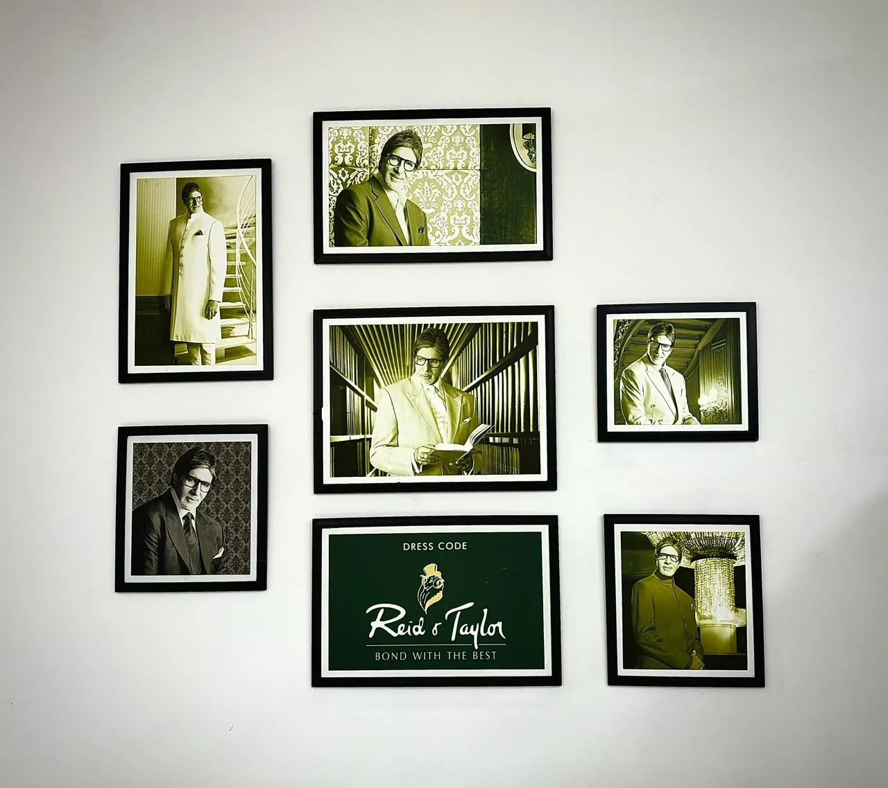 Framed Reid & Taylor campaign photographs arranged around the green Reid & Taylor logo card at the Reid & Taylor showroom in Basaveshwaranagar